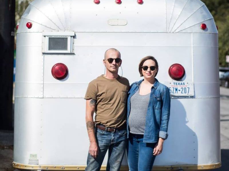 Couple standing in front of motor home
