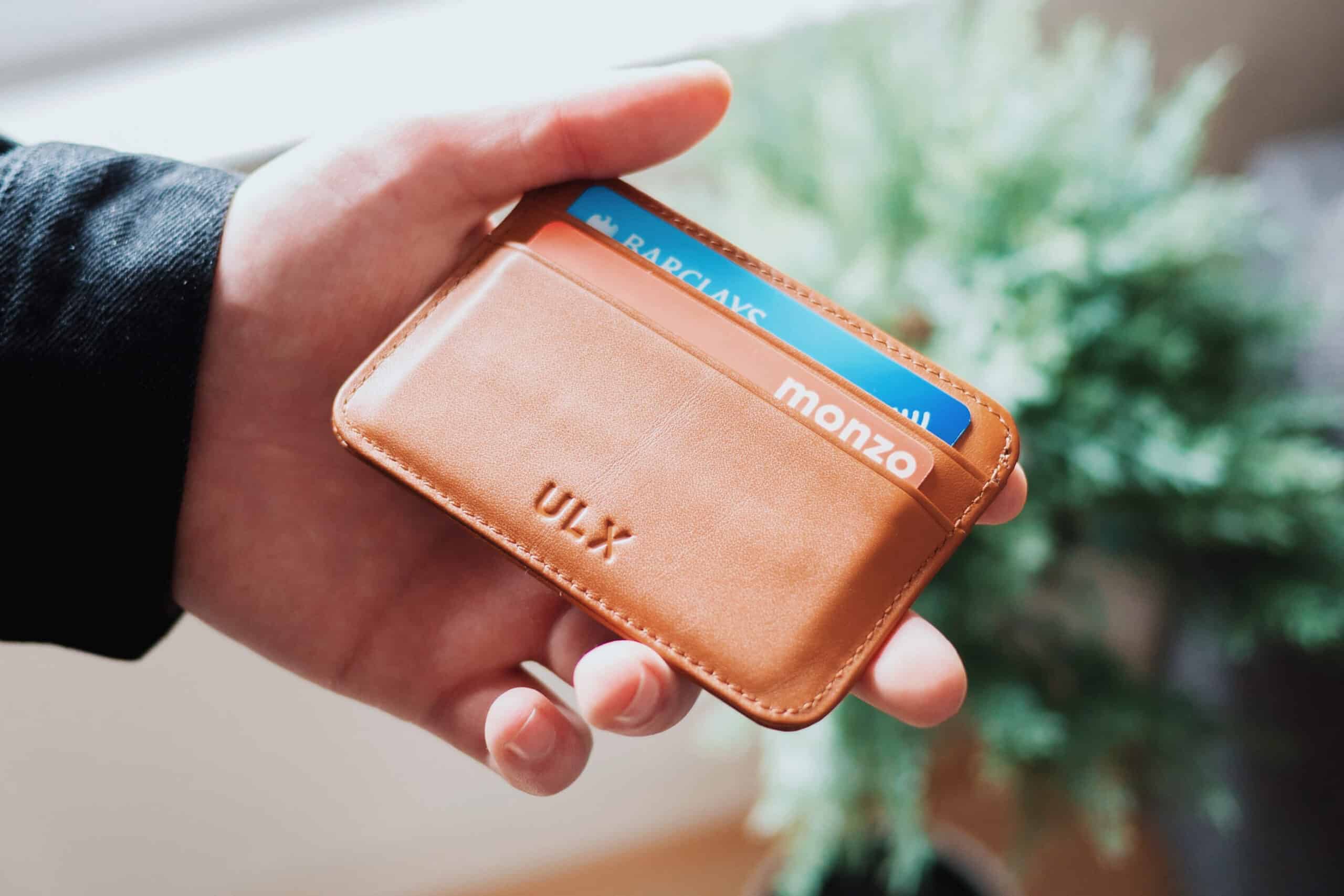 hand out with wallet showing credit cards