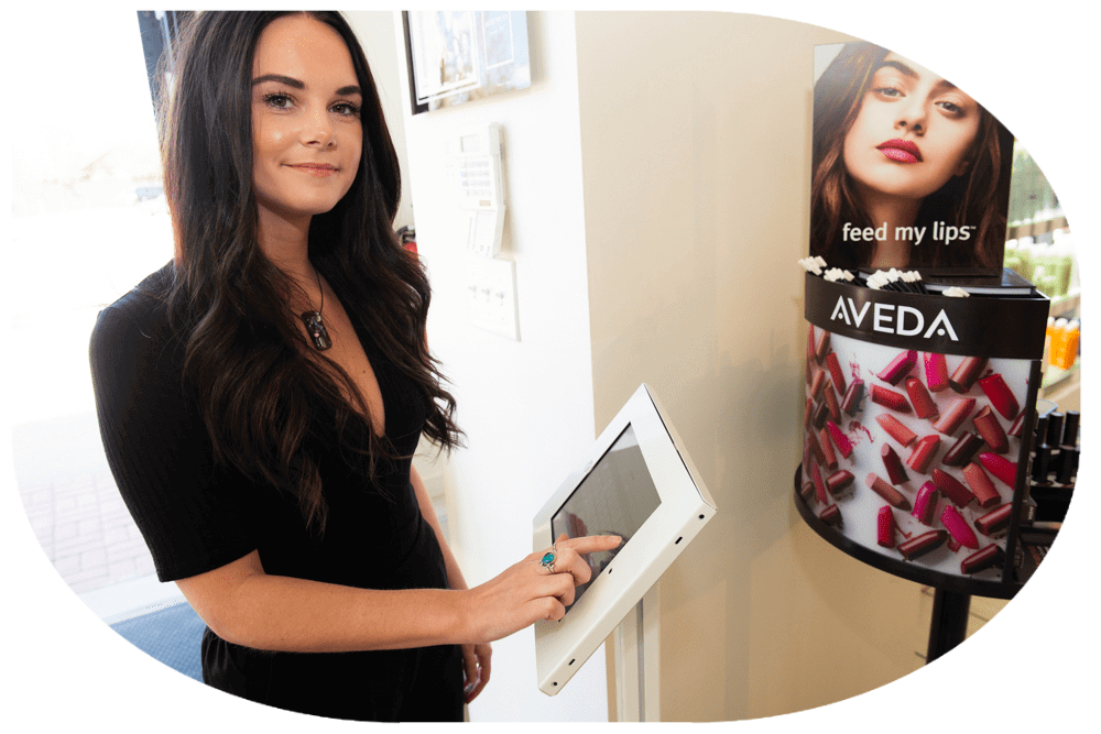 Salon employee using an Ipad in the front of the store