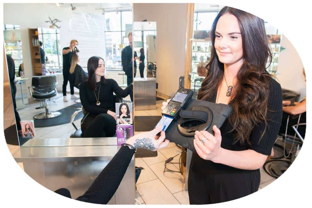 Customer paying via iPad at hair salon