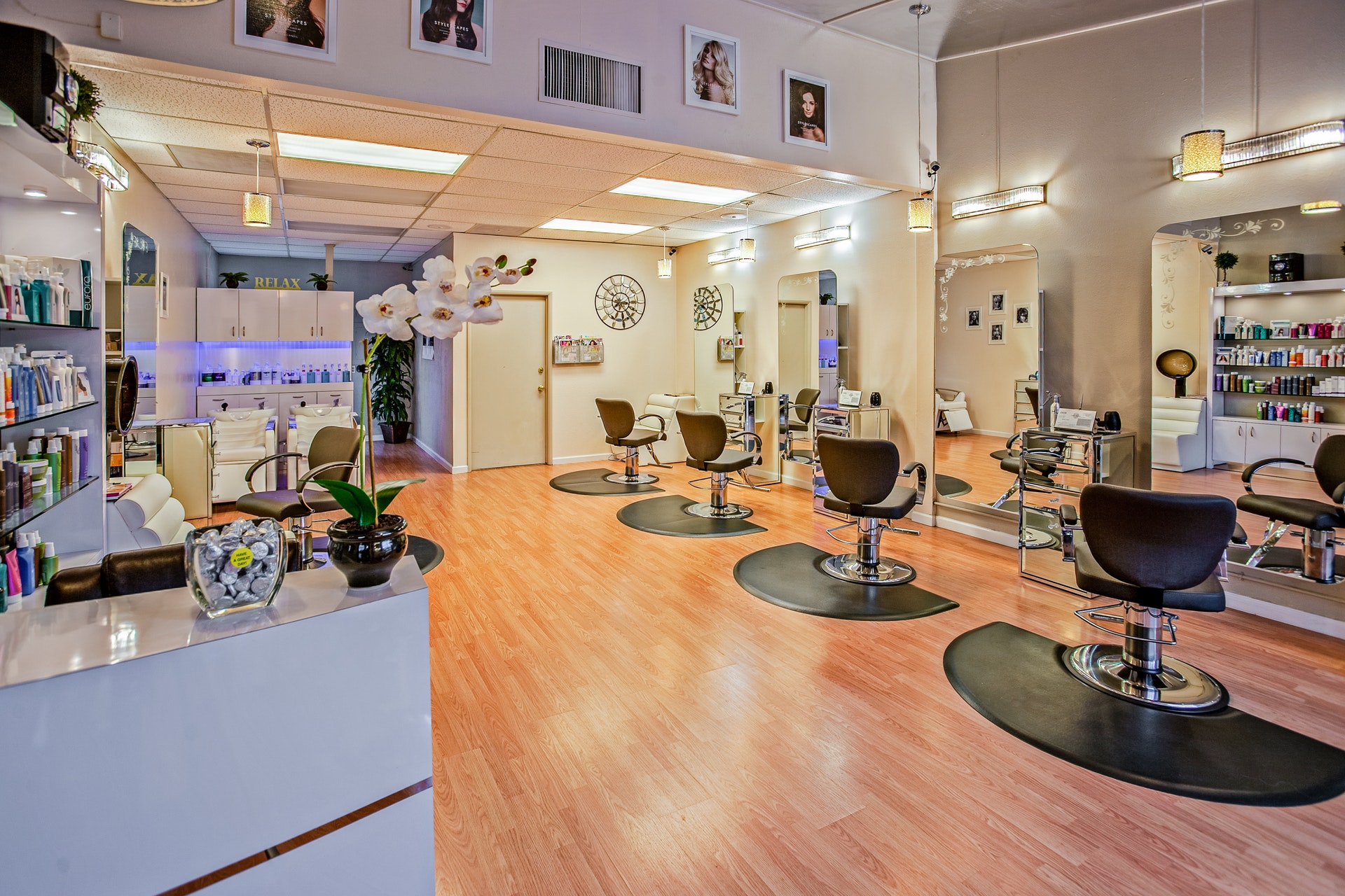 a view of an interior area of a salon with front desk and salon chairs