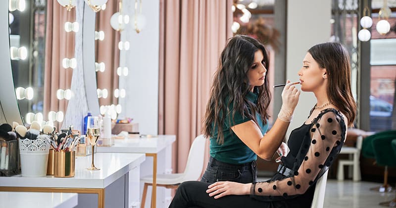 Salon stylist doing clients makeup