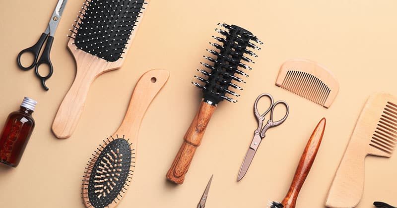 hair salon styling tools on a tan background