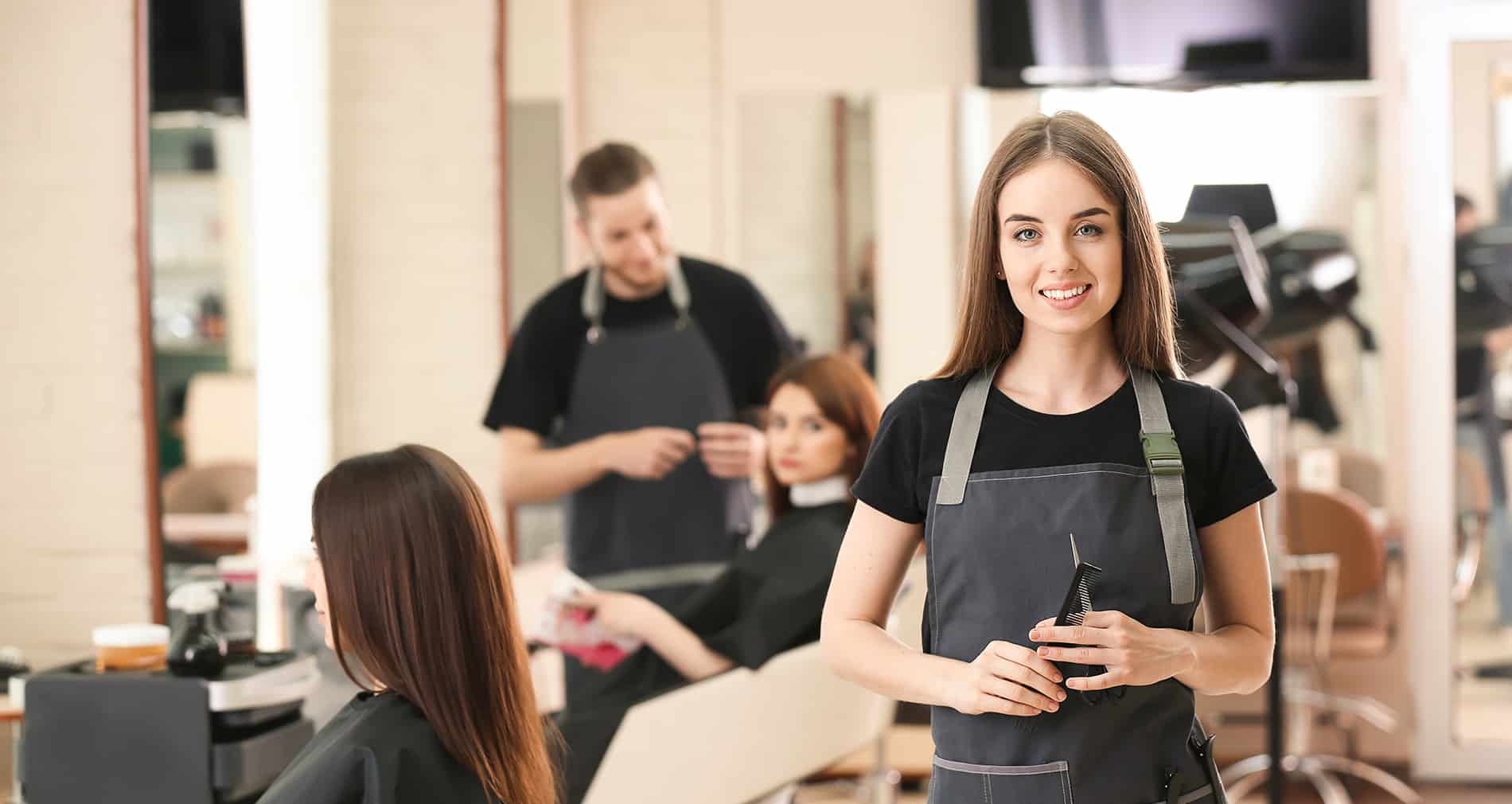 a woman in a hair salon standing with the team