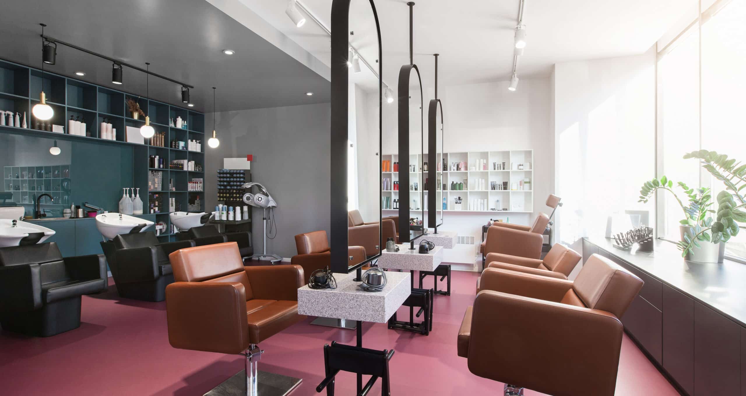tan leather salon chairs and blue back wall