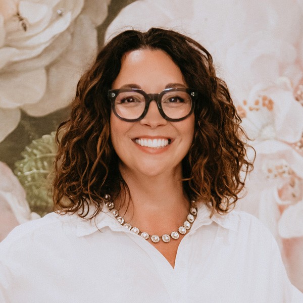 Amy Carter. Picture of tan-skinned woman with dark, short curly hair in white blouse.