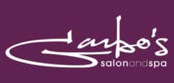 Logo for Garbo's Salon and Spa with white, stylized cursive text on a purple background, featured in a software demo. "Garbo's" is prominent, with "salonandspa" in smaller, lowercase letters underneath.