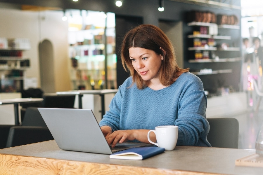 A salon owner using her SalonBiz app