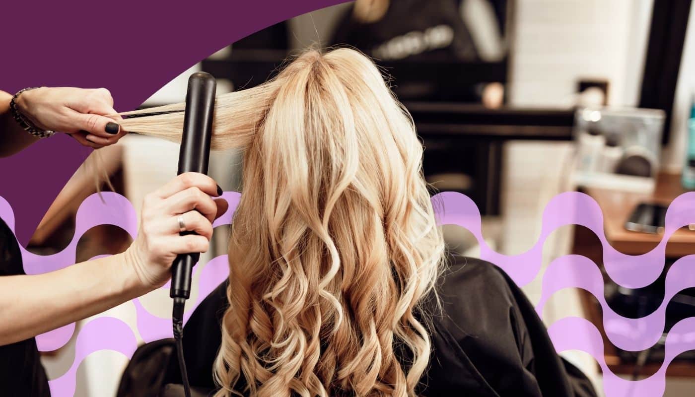 Hairstylist uses a flat iron to smooth and style a client’s long blonde hair in a salon. The image features soft curls, professional hair styling tools, and decorative purple graphic elements that emphasize salon services and beauty styling.