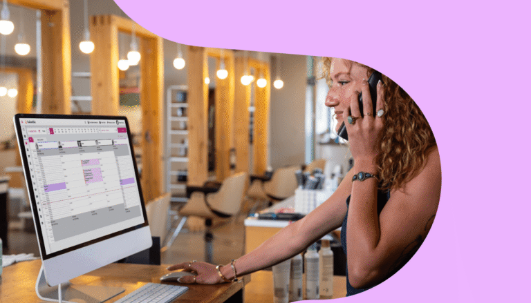 Salon front desk staff welcoming a client, supporting salon client retention through a warm in-person experience