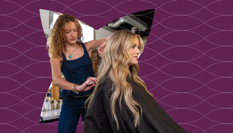 A hair stylist working with a client in the salon chair