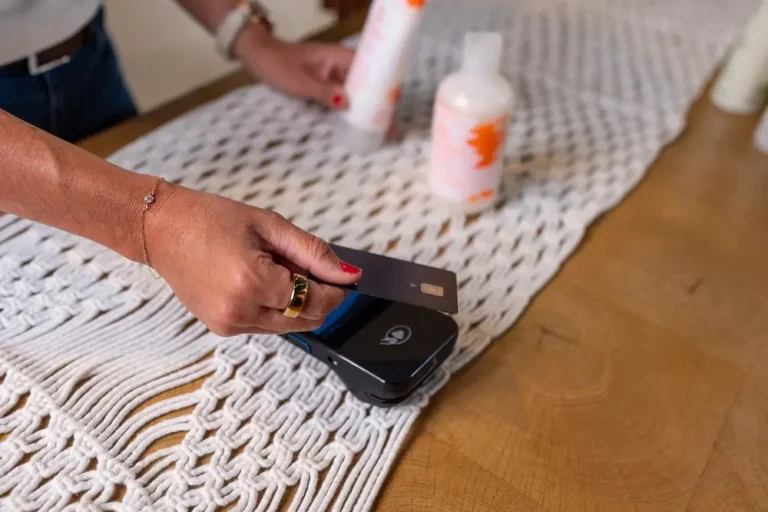Closeup of person using tap to pay at a salon POS system