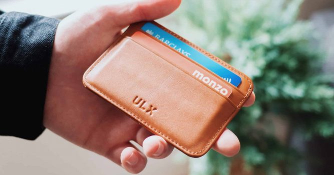 hand out with wallet showing credit cards