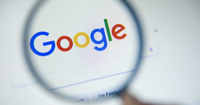 Paris, France - October 19, 2017 : Google.fr homepage on the screen under a magnifying glass. Google is world's most popular search engine