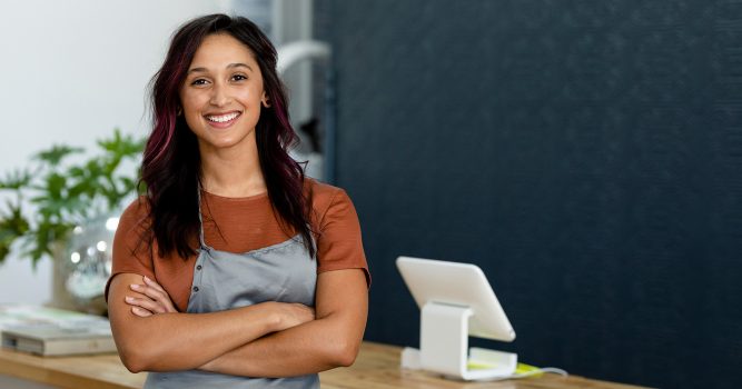 a stylist standing with arms folded