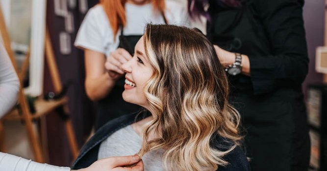 Smiling woman in hair salon chair