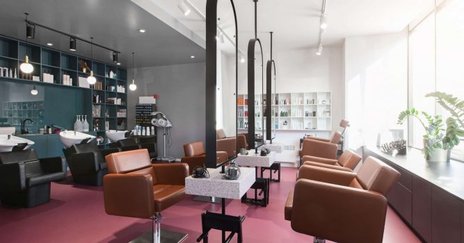 tan leather salon chairs and blue back wall