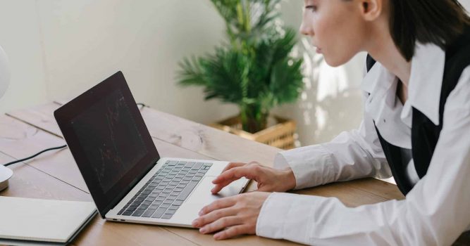A lady using a laptop to review her work